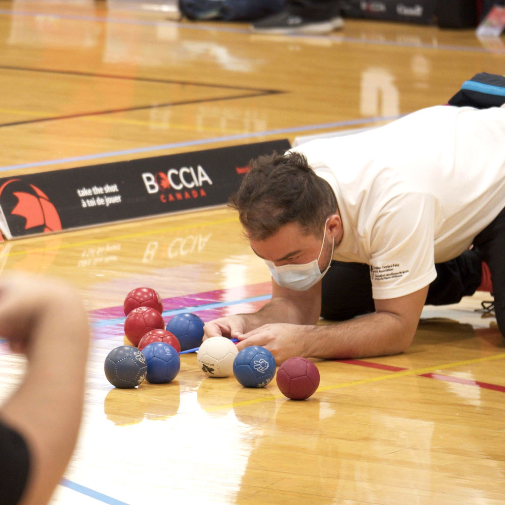 Person measuring boccia ball distances